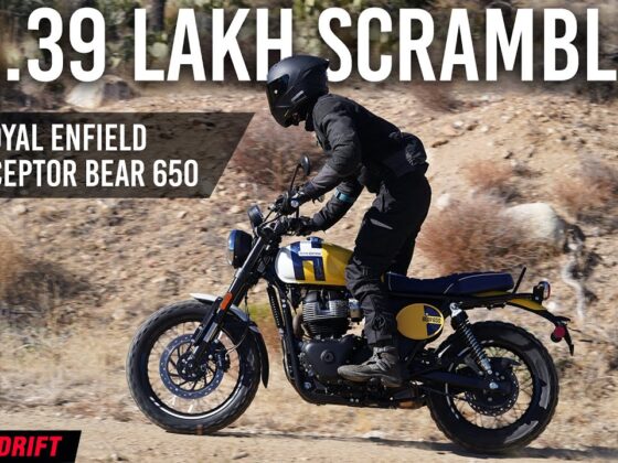 Royal Enfield Interceptor Bear 650 riding on a hilly terrain with a rider in black leather gear.