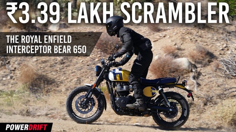 Royal Enfield Interceptor Bear 650 riding on a hilly terrain with a rider in black leather gear.